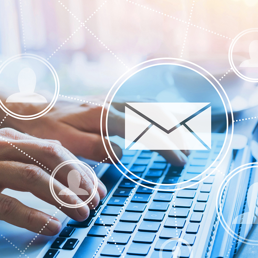 Hands on a keyboard with email icons
